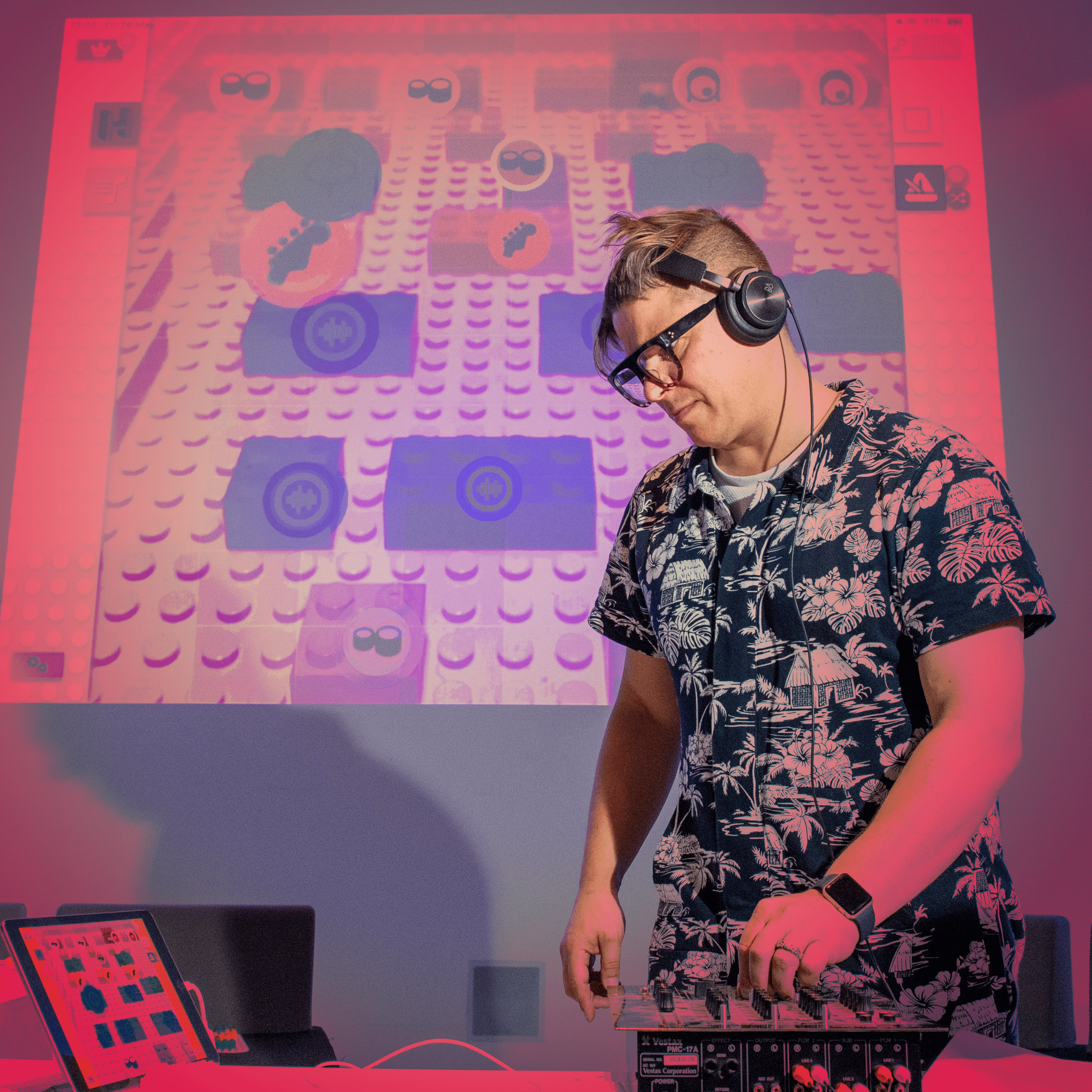 DJ on laptop controlling lego bricks on screen